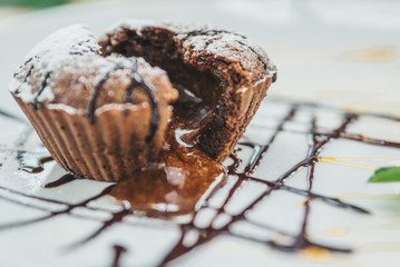 chocolate fondant close up on white plate. soft focus