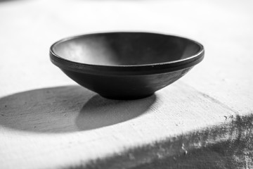 Empty black bowl in table