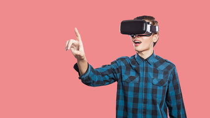 Young man with vr headset on pink background.