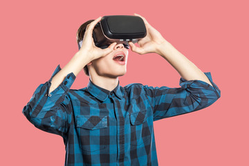 Young man with vr headset on pink background.
