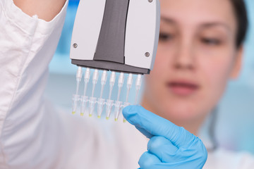 Young woman with genetic research in the laboratory research of cancer diseases