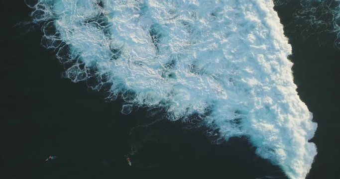 High Aerial View Of Surfers Surfing On Turquoise Waves