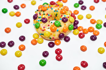 Appetizing golden donut sprinkled with colorful chocolate pellets.