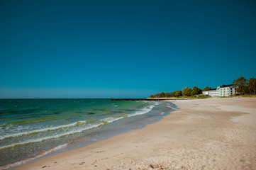 Beautiful sunny beach with white sand at the clear blue Baltic sea in Ystad, Southern Sweden.