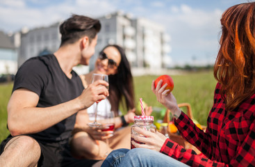 Picnic at sunny day, group of happy people having fun enjoying summer