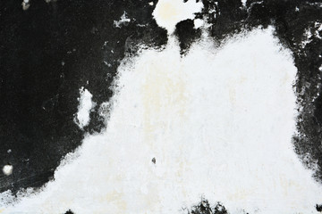 Old white wall with sloppy black streaks.