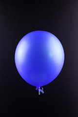 Blue balloon isolated on black