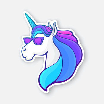 Sticker of fairy tale unicorn head in sunglasses with a rainbow mane
