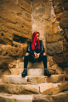 Woman in rebel outfit on stone steps