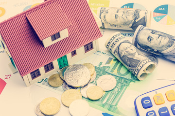 Home loan / reverse mortgage or transforming assets into cash concept : House model on pile of...