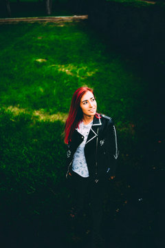 Stylish woman in jacket on grass