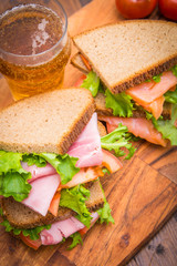 sandwiches with ham and smoked salmon with beer glasses