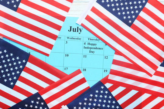 American flags with paper july calendar