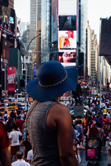 Woman in hat looking out at Times Square