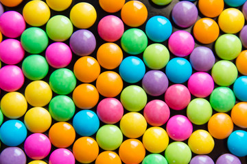 Pile of colorful sweet candy chocolates coated background. colourful collection