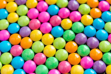 Fototapeta na wymiar Pile of colorful sweet candy chocolates coated background. colourful collection
