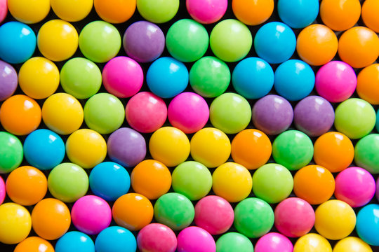 Pile of colorful sweet candy chocolates coated background. colourful collection