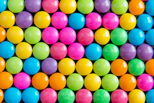 Pile of colorful sweet candy chocolates coated background. colourful collection