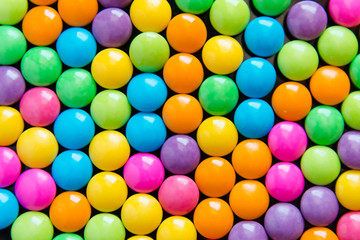 Pile of colorful sweet candy chocolates coated background. colourful collection