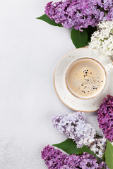Obraz na płótnie Canvas Colorful lilac flowers and coffee cup