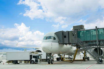 Loading cargo on plane in airport. cargo plane loading for logistic and transport. view through window Passenger terminal