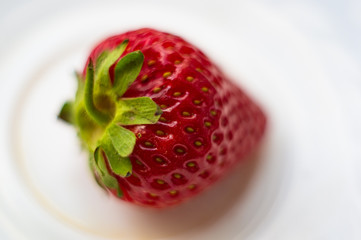fresh ripe strawberries on black ceramic plate