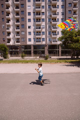 Young boy flying kite in the park on a sunny day