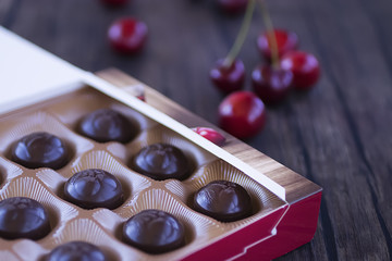 Chocolate sweets with cherry liqueur in paper box.