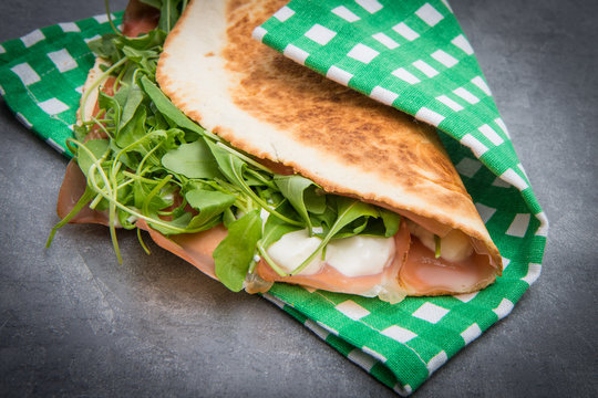 typical piadina romagnola with ham, cheese and rocket