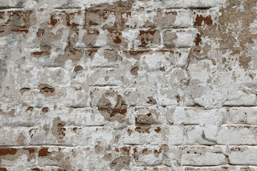 Background of old vintage dirty brick wall with peeling plaster, texture