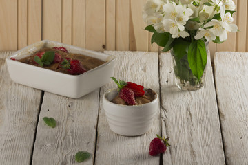 Cottage cheese casserole in white dish decorated with strawberries