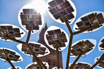The sun gives energy to the solar panels and illuminates the mosque. Photograph taken at the...