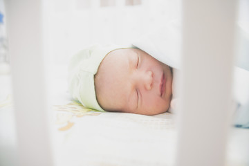 close-up baby newborn infant lying in bed