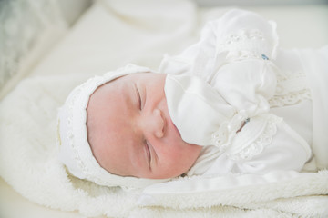 close-up baby newborn infant lying in bed