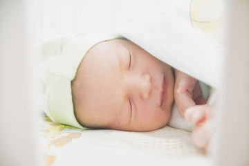 close-up baby newborn infant lying in bed