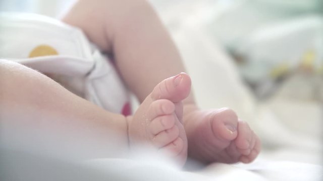 close-up of leg baby newborn infant lying in bed