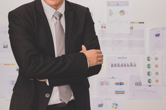 Male model in a suit posing on office background