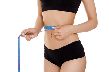 woman measuring waist with blue measuring tape.