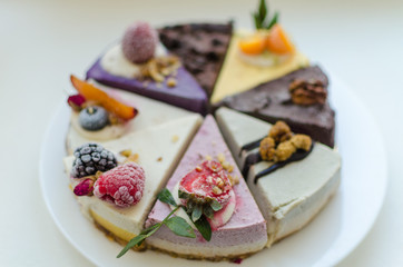 different pieces of cake on cake stand © Dmitri