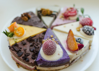 different pieces of cake on cake stand © Dmitri