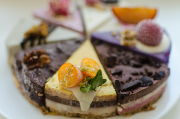 different pieces of cake on cake stand © Dmitri