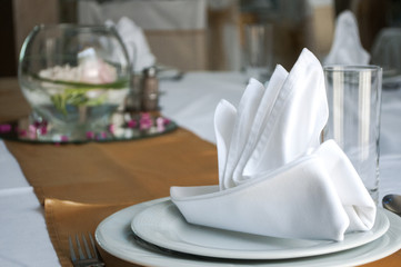 Napkins in the shape of a ship for decoration at a wedding