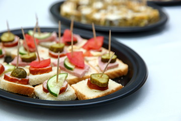 Popular and appetizing sandwiches for one bite pierced with a toothpick.