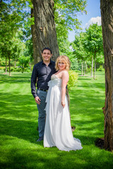 Bridal wedding plus size couple woman and man sitting with heads together on park.    