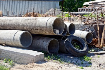 concrete pipes and old tire on the construction site