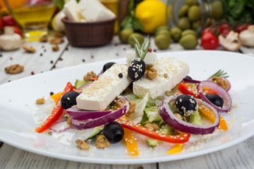 Greek salad with fresh vegetables, feta cheese and black olives