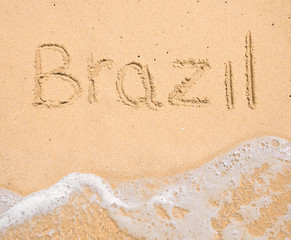 The word Brazil written in the sand on beach