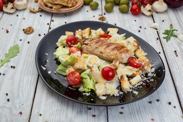 Healthy Grilled Chicken Caesar Salad with Cheese, Croutons and Cherry Tomatoes