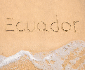 The word Ecuador written in the sand on beach