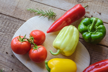 Selection of colorful vegetable on wooden table. Cooking fresh food background.